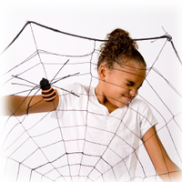 girl holding giant spider web decoration